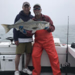 Captain Mike Abdow and charter customer holding recently-caught large bass