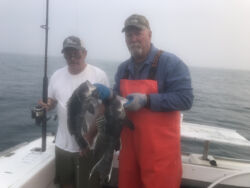 Captain Mike and customer holding up two black bass