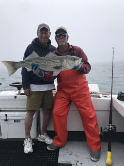 Captain Mike Abdow and charter customer holding recently-caught large bass